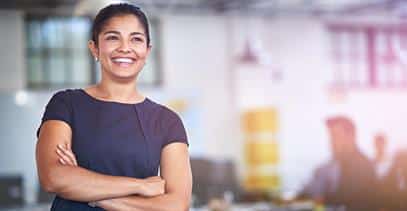 a business person smiling with her arms crossed