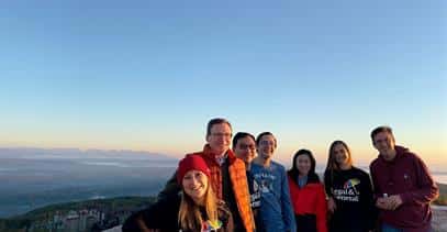 a group of people standing on a mountain